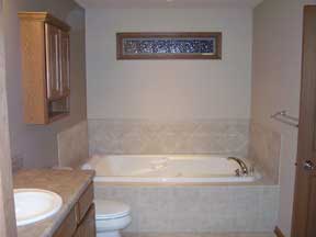 tub with glass block window