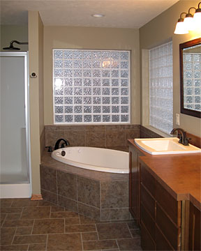 Tcorner whirlpool tub with glass block window