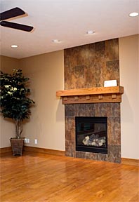 custom tile fireplace and wood mantel