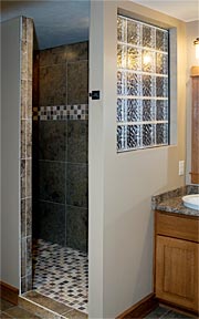 walk-in tile shower with glass block wall
