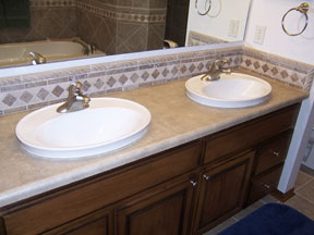 his and her sinks with custom tile backsplash
